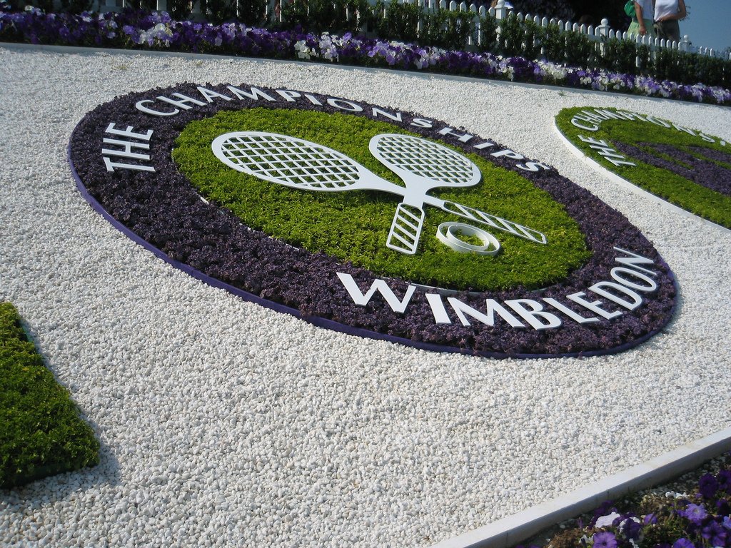 Ornamental garden display shaped like crossed tennis rackets reading 'Wimbledon'