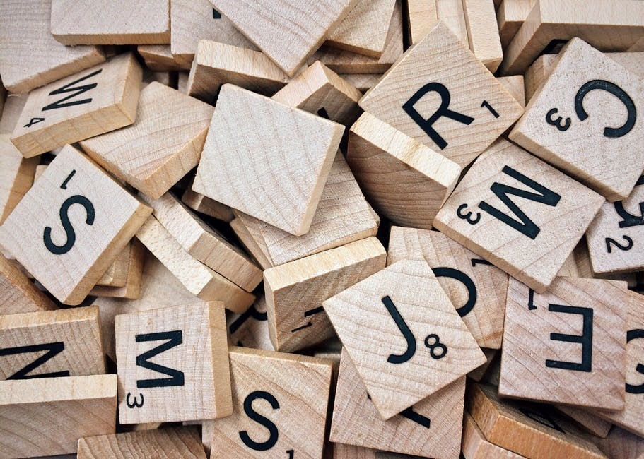 Wooden Scrabble pieces assorted randomly