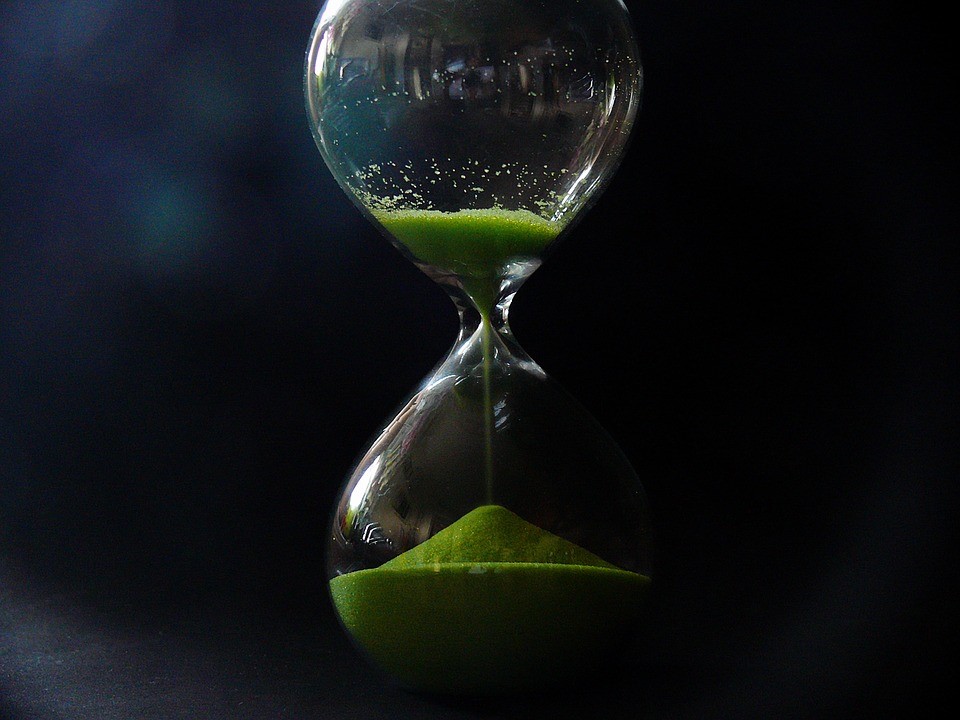 An hourglass with green sand
