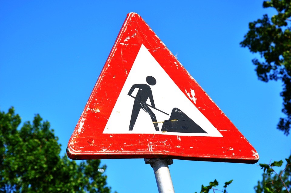 A red roadworks triangle sign