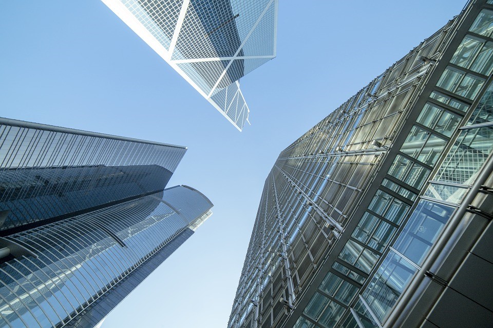 Upward shot of three skyscrapers on a sunny day