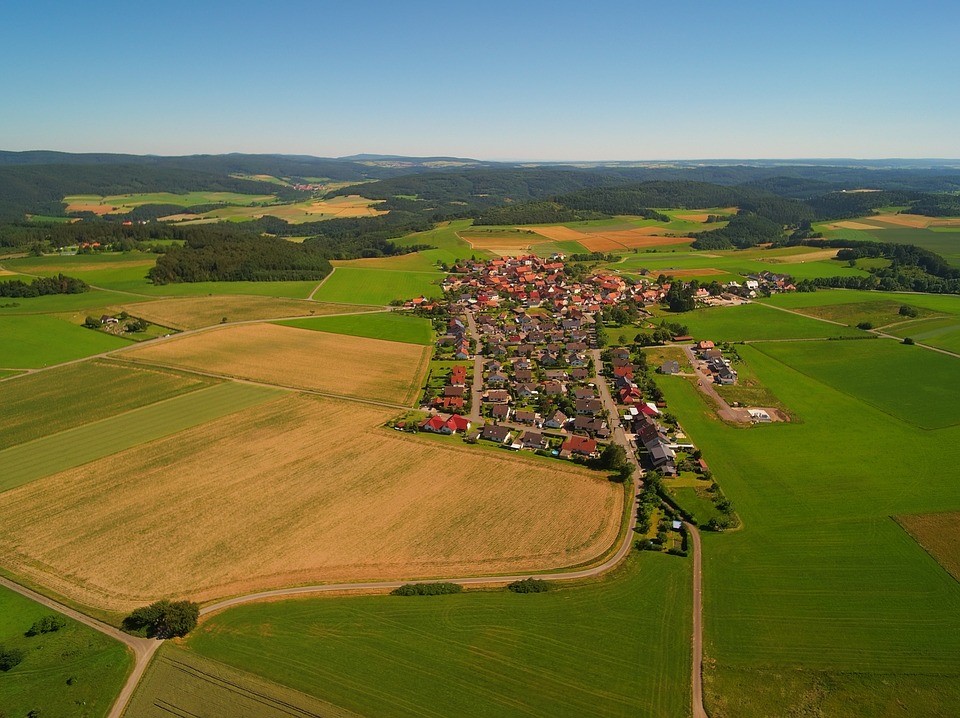 Aerial view of village surrounded by land