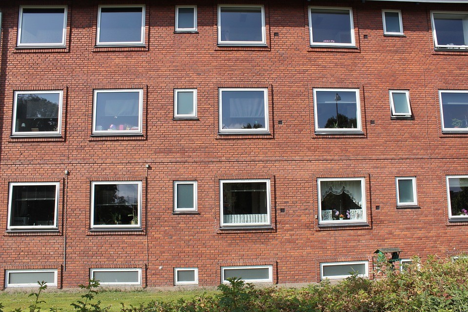 Side view of an apartment building with multiple windows