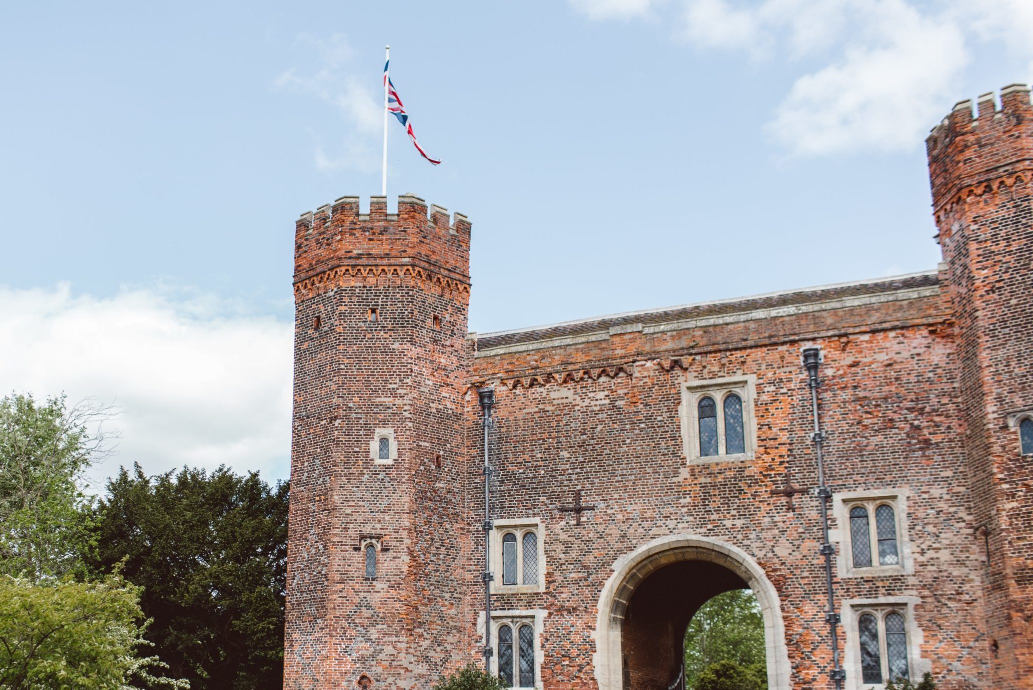Exterior view of a castle flying the British flag