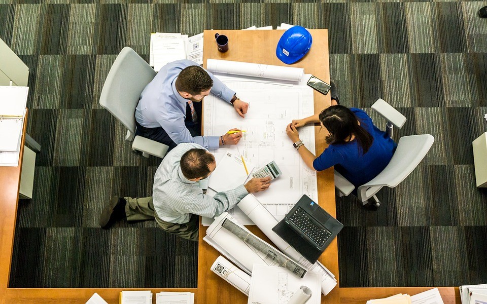 Birds eye view of an office table surrounded by workers