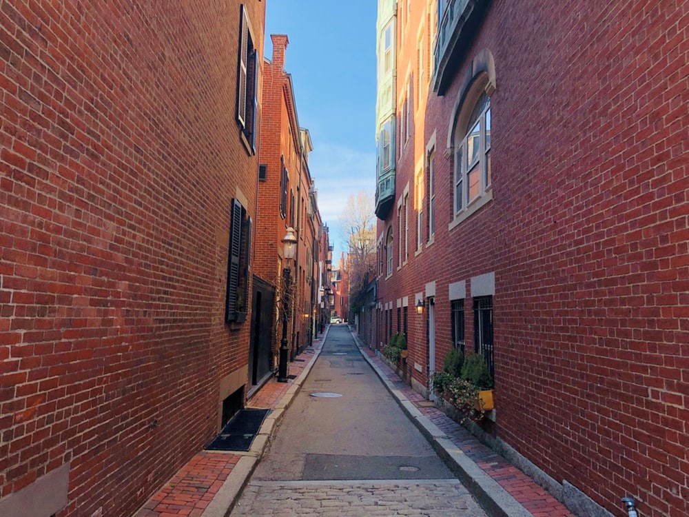 An alleyway between red brick buildings