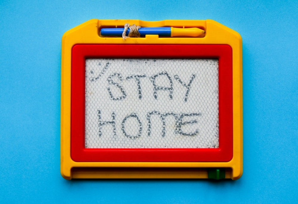 An etch-a-sketch with the words 'Stay Home'