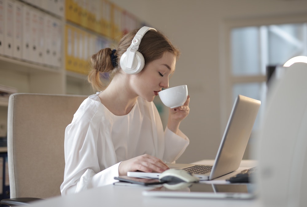 woman listening to music in office